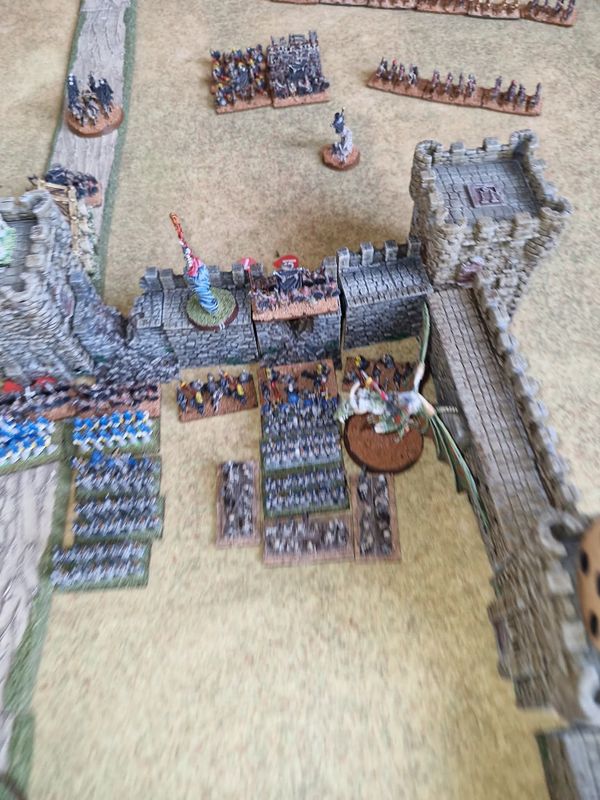 Undead forces pouring through a breach in the castle wall as Elven defenders and a lich priest on undead dragon clash in the courtyard