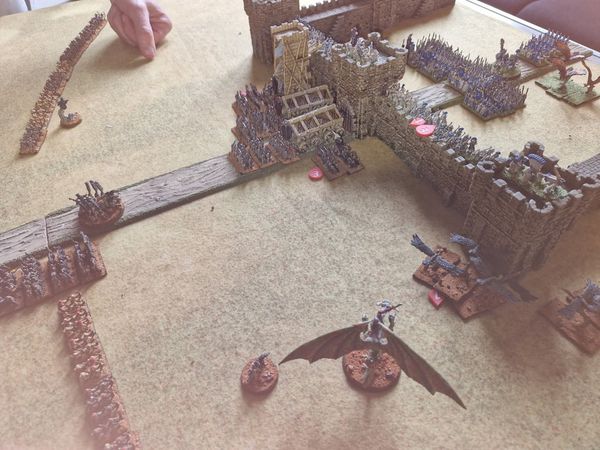 Castle walls breached with Tomb King siege equipment and undead dragon closing in as the assault reaches its height